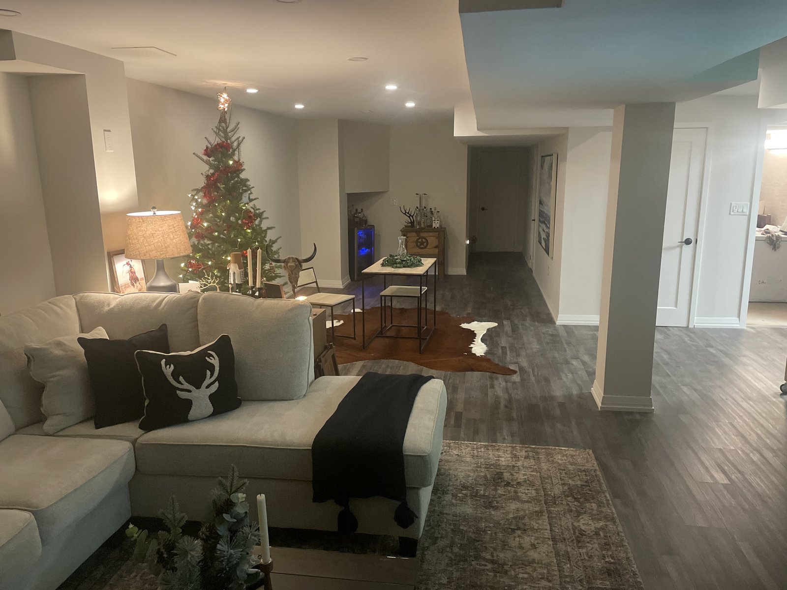 Finished basement living area with sectional sofa and recessed lighting