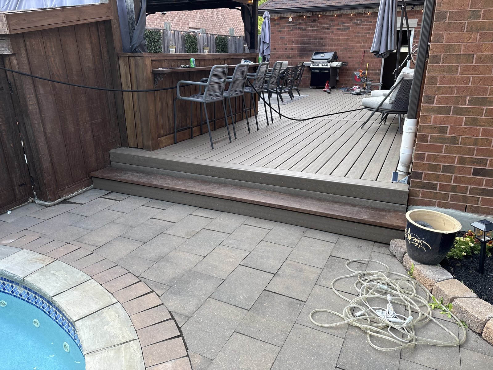 Composite deck with stone patio next to pool
